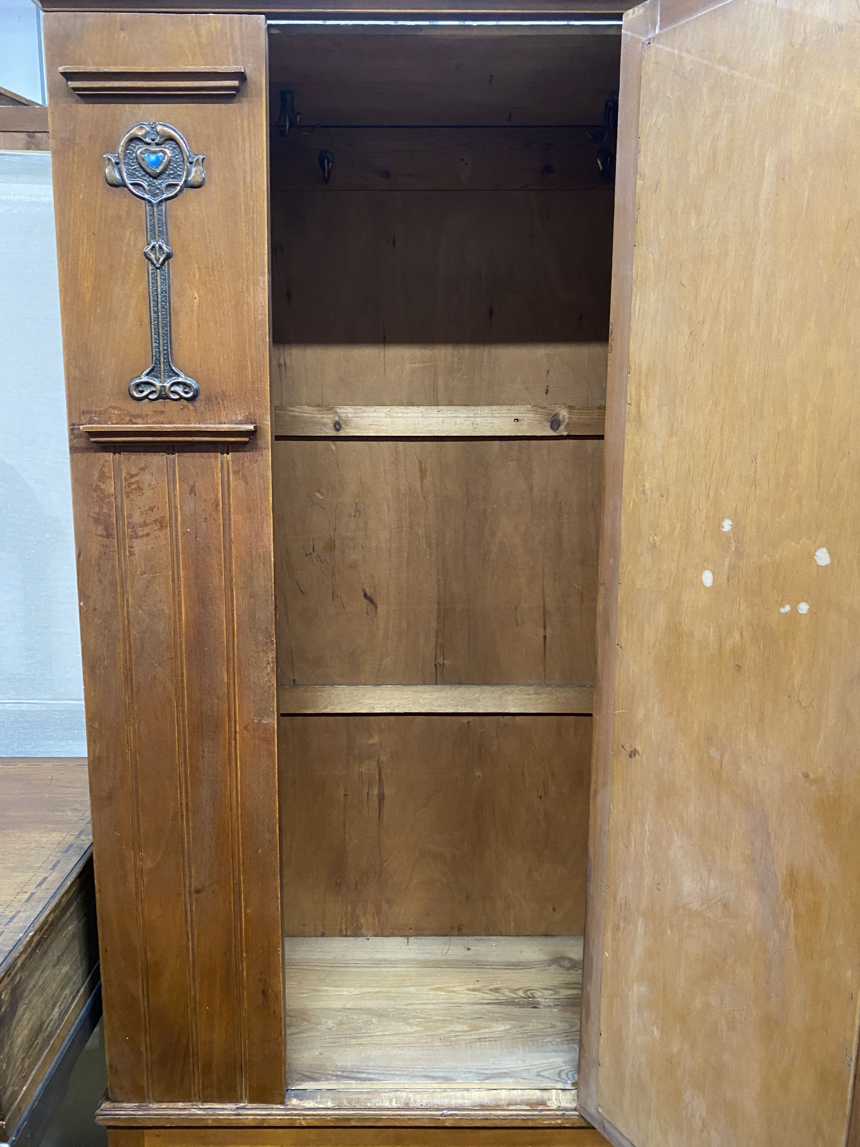 An early 20th century Arts & Crafts mirrored walnut wardrobe, length 96cm, depth 39cm, height 188cm